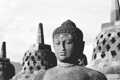 Statue of temple against building