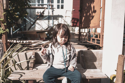 Full length of boy sitting on seat