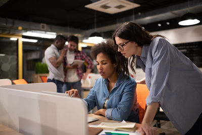 Diverse female colleagues working on project together