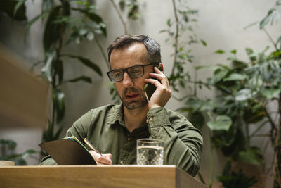 Midsection of man using smart phone outdoors