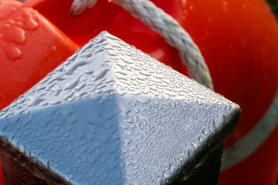 Close-up of chromed metal and signal orange background 