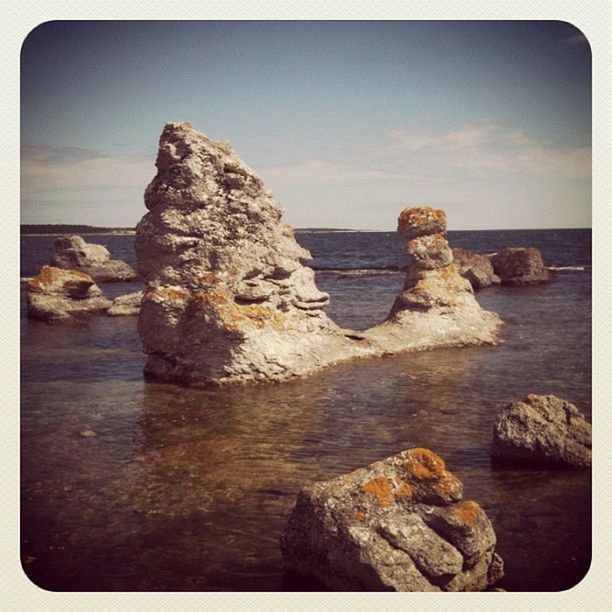 water, transfer print, sea, rock - object, rock formation, tranquil scene, tranquility, rock, scenics, sky, auto post production filter, horizon over water, beauty in nature, nature, idyllic, shore, beach, cliff, outdoors, stone