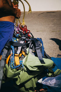 Midsection of man wearing harness outdoors