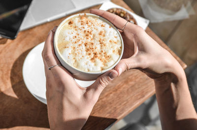 Woman holding cup of coffee