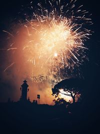 Low angle view of firework display at night