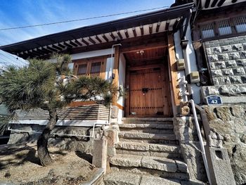 Steps by building against sky