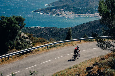 Man riding bicycle on road