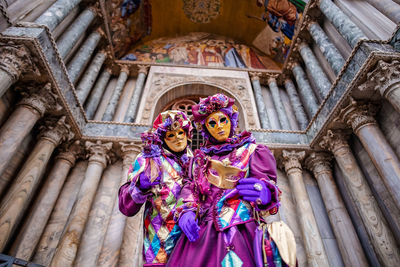 Low angle view of woman holding umbrella