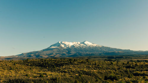 Scenic view of mountains against clear blue sky