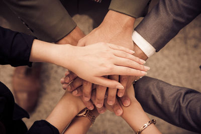 High angle view of business people stacking hands