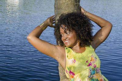 Portrait of young woman looking at lake