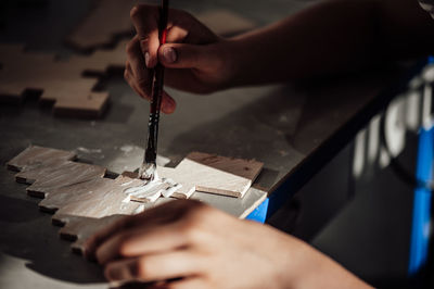 Cropped hand of person working in workshop