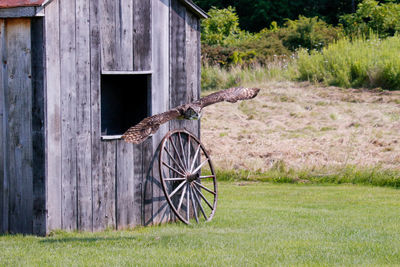 Abandoned bicycle on field by old building