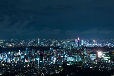 High angle view of illuminated city buildings at night