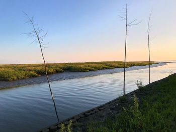 Scenic view of lake against sky during sunset