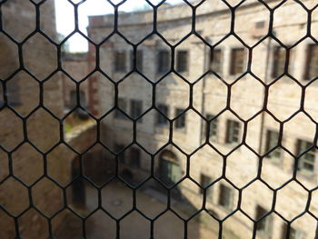 Full frame shot of soccer field seen through chainlink fence