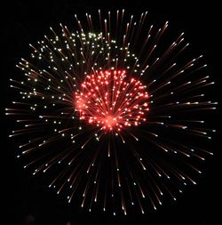 Low angle view of firework display at night