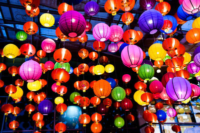 Low angle view of illuminated lanterns hanging at night