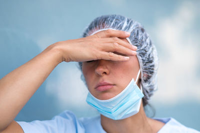 Tired, overworked, exhausted health care worker resting her head taking a break