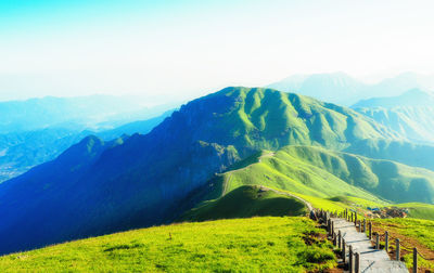 Scenic view of mountain range against blue sky