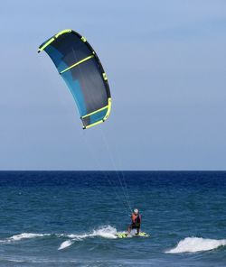 People enjoying in sea against sky