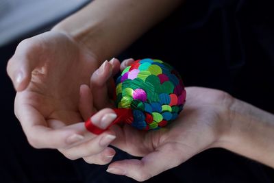 Close-up of person holding multi colored candies