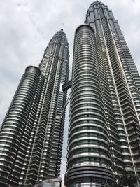 Low angle view of modern building against cloudy sky