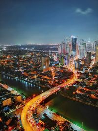 High angle view of illuminated buildings in city at night