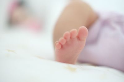 Low section of baby feet