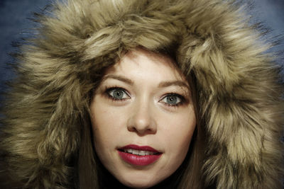 Close-up portrait of a young woman in winter