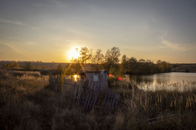 Scenic view of lake against sky during sunset