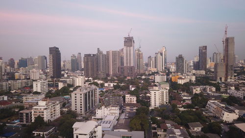 Aerial view of modern buildings in city against sky