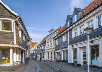 Street amidst buildings against sky