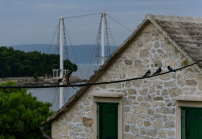 Exterior of building by river against sky