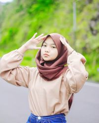 Portrait of beautiful young woman standing in park