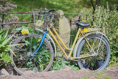 Bicycle parked in basket on field