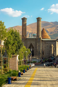 Double minaret madrasa.background palandoken mountain. erzurum, turkey