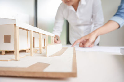 Midsection of woman working on table