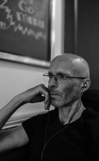 Mature man looking away while sitting at cafe