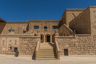 Low angle view of old building against blue sky