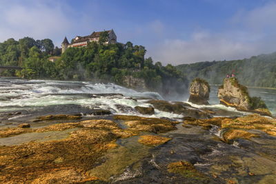 Scenic view of waterfall against sky