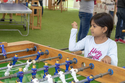 Cute girl playing foosball 