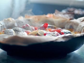 A frying pan just removed from the oven with baked potatoes with vegetables and chum 