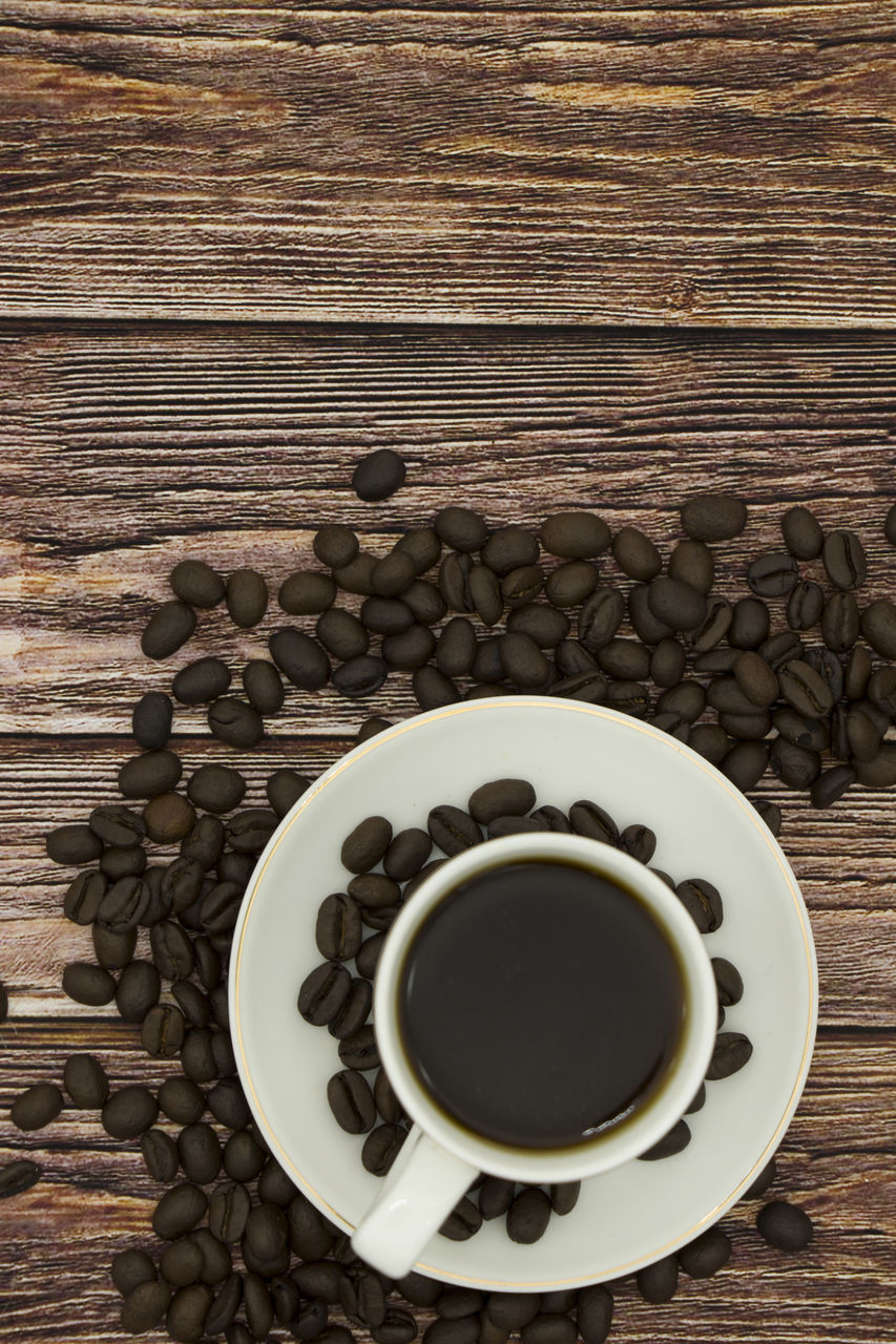 HIGH ANGLE VIEW OF COFFEE CUP AND SPOON ON TABLE