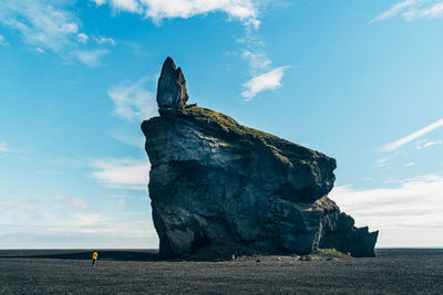 Scenic view of rock on beach against sky