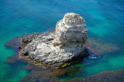 High angle view of rocks on sea