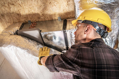 Rear view of man working at construction site