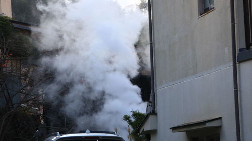 Smoke emitting from car in city