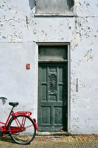 Bicycle against white door