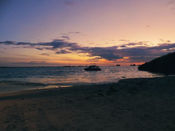 Scenic view of beach against sky during sunset